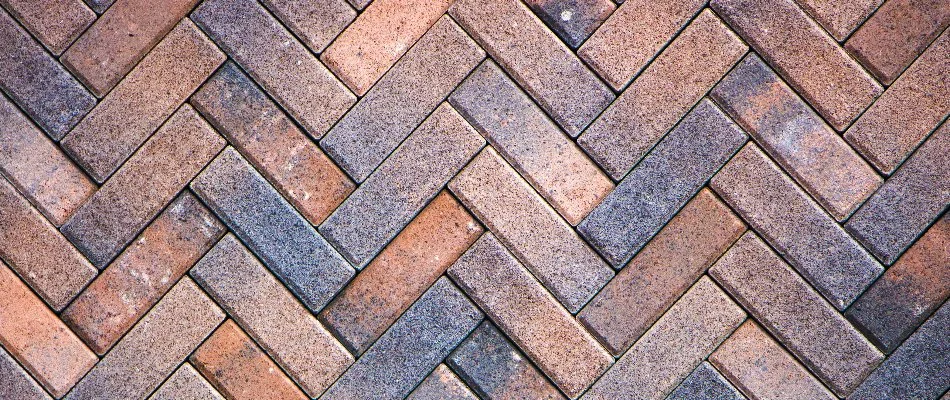 Patio pavers in Huntsville, AL, making a herringbone pattern.