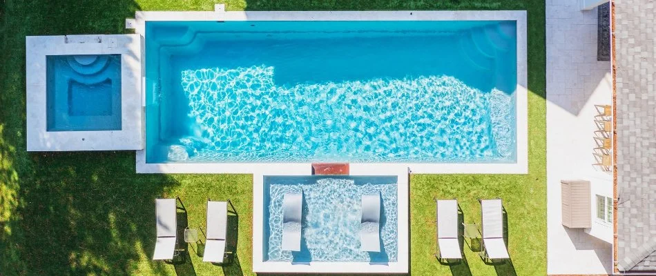 Large pool with seating area in Huntsville, AL.