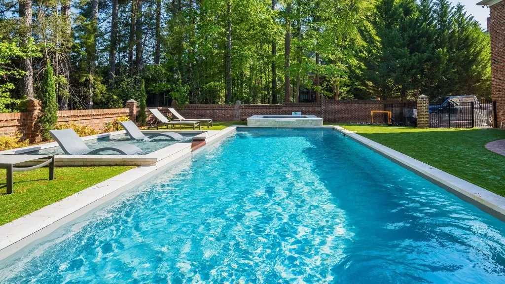 Beautiful home in Madison, AL with a pool and spa featuring a sun shelf.