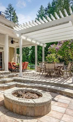 Circular fire pit in backyard living space at a home in Meridianville, AL.